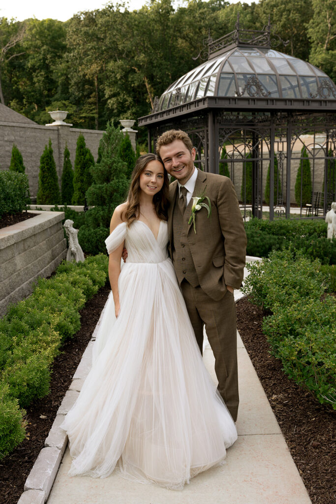 Couple smiling at the camera during their photoshoot