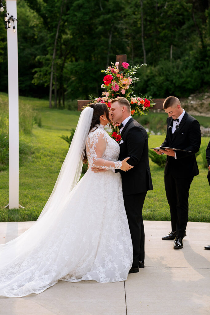 bride and groom kissing after their wedding ceremony