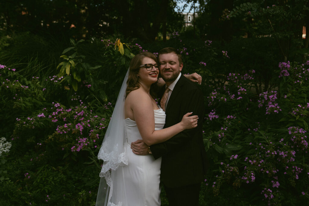 portrait of the bride and groom smiling at the camera during their photoshoot