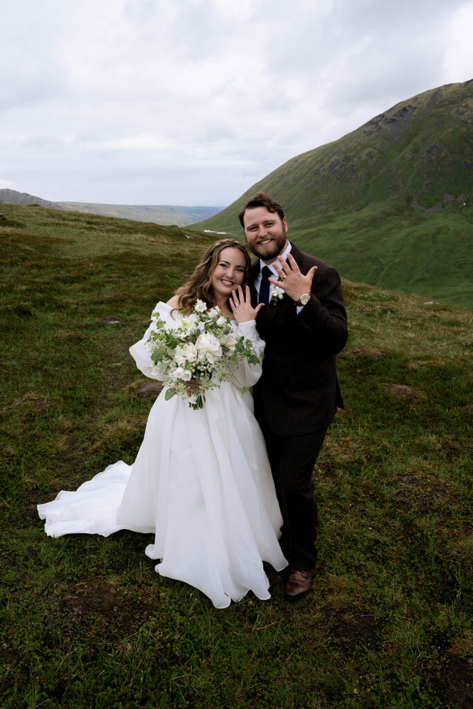 cute portrait of the couple showing their wedding rings