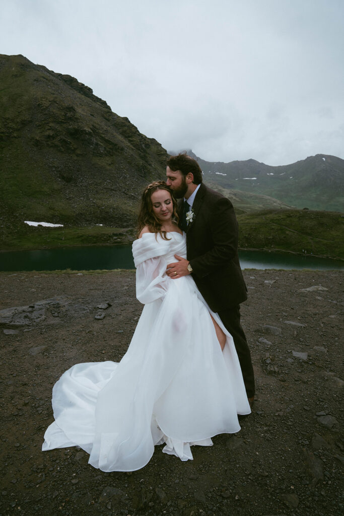 groom kissing the bride on the forehead