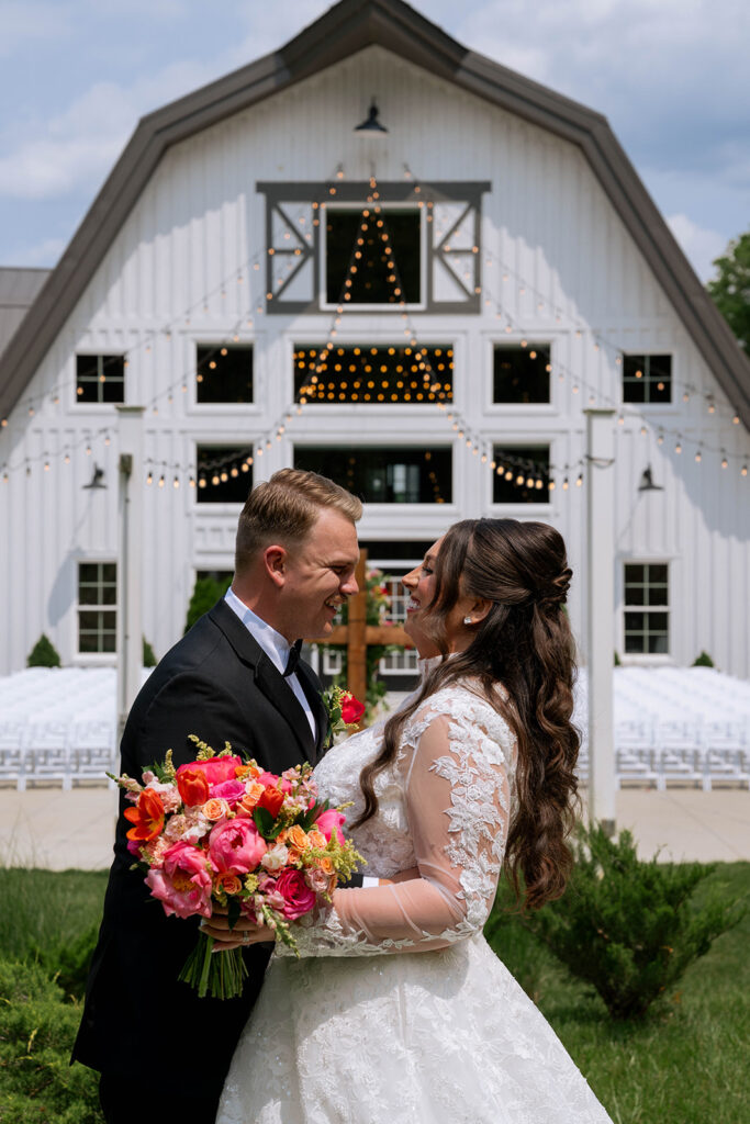 portrait of the bride and groom smiling with each other 