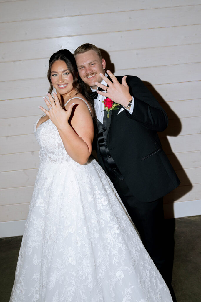 picture of the bride and groom showing their wedding rings