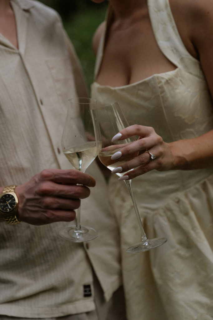 couple celebrating their engagement with champagne 
