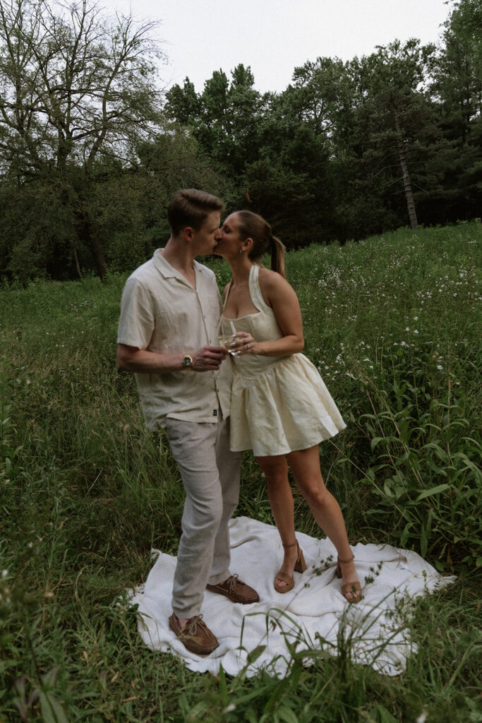 picture of the newly engaged couple kissing