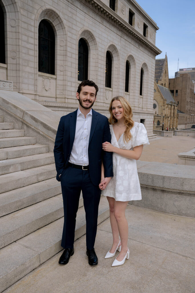 Couple smiling at the camera during their engagement photos