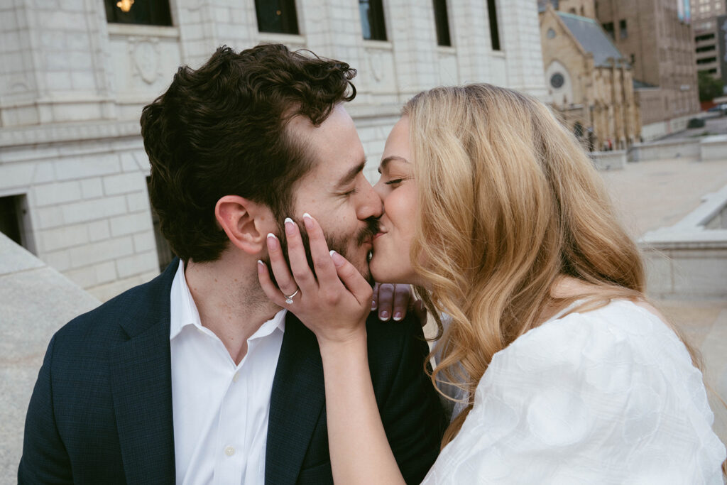 Cute picture of the newly engaged, couple kissing