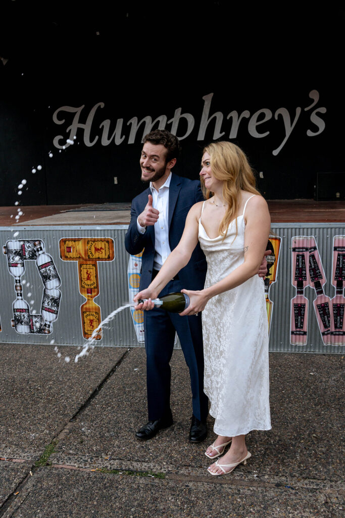 couple celebrating their engagement with champagne