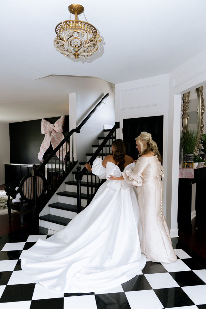 Mother of the bride, helping the bride with the wedding dress