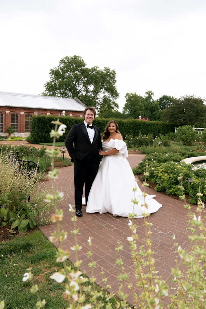Cute picture of the bride and groom, smiling at the camera during their bridal portraits
