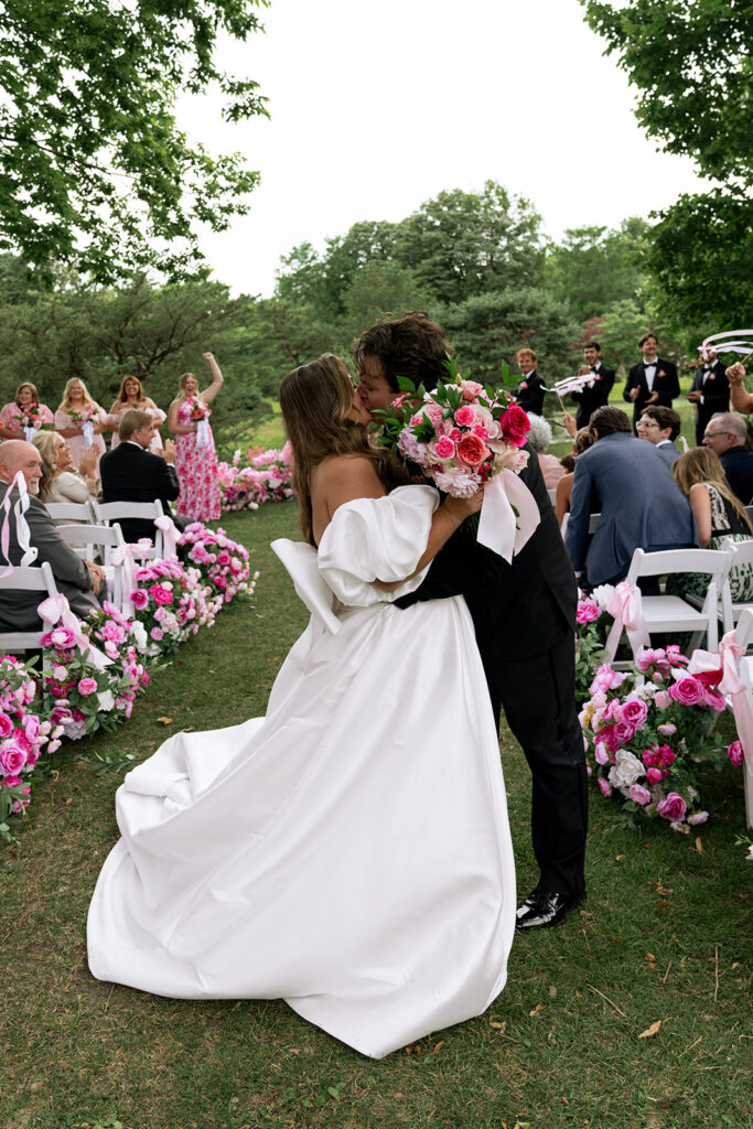 picture of the bride and groom kissing after their ceremony