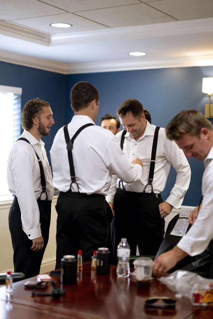 groom and his groomsmen getting ready for their ceremony