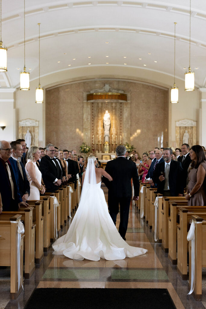 Stunning picture of the bride walking down the aisle