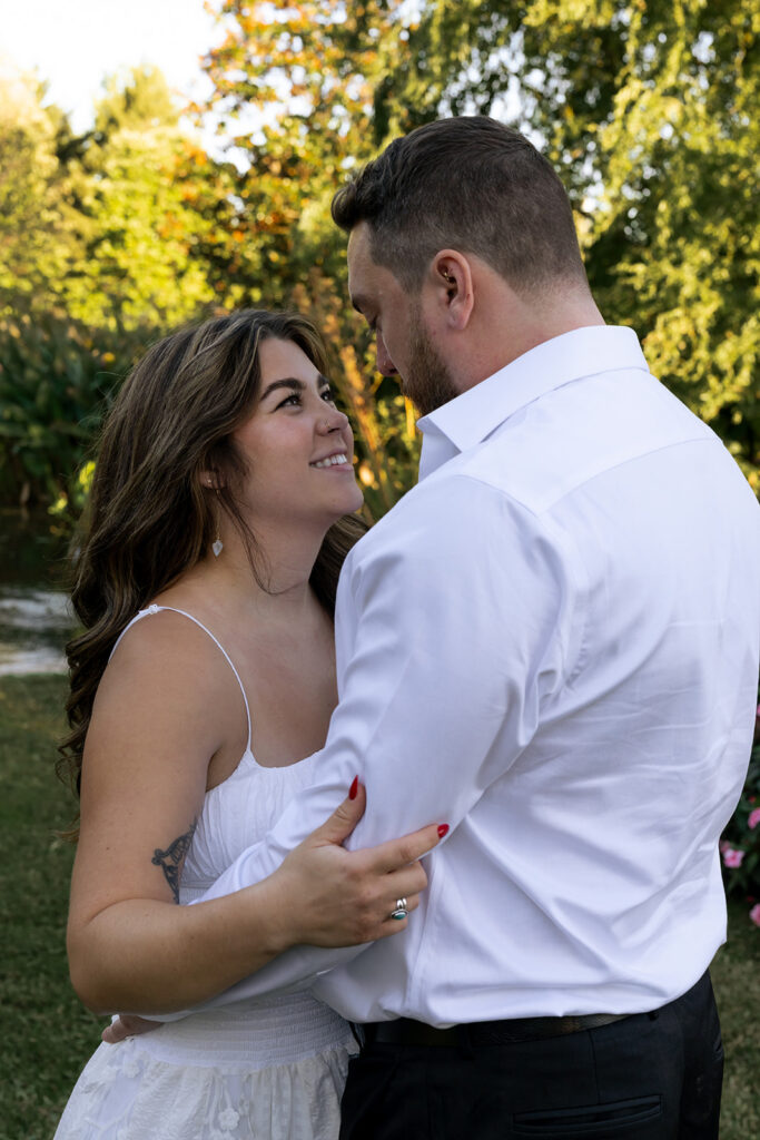 cute picture of the newly engaged couple smiling at each other 