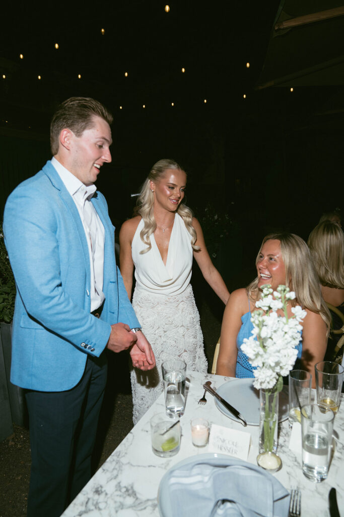 bride and groom at their dinner with their family before the wedding day