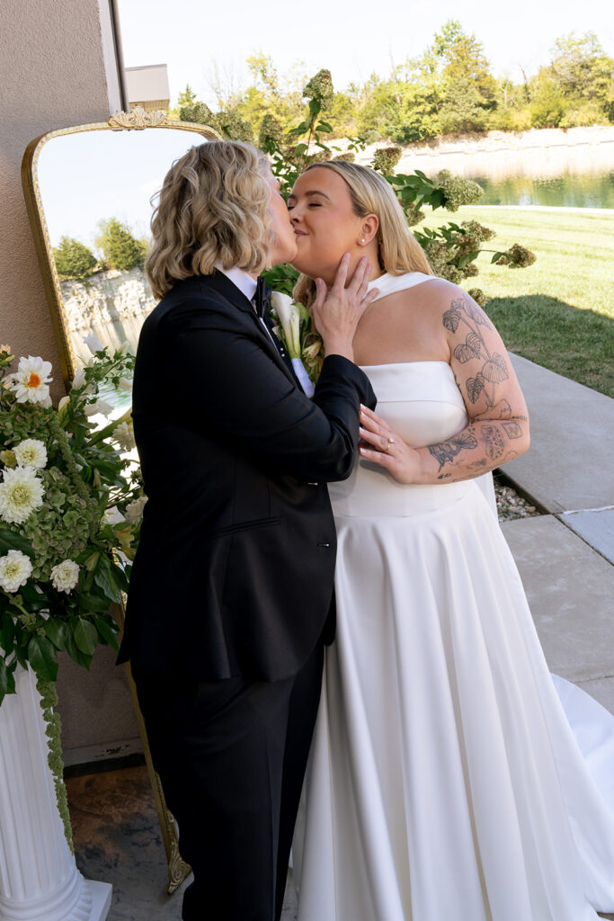 bride kissing her bride on the cheek