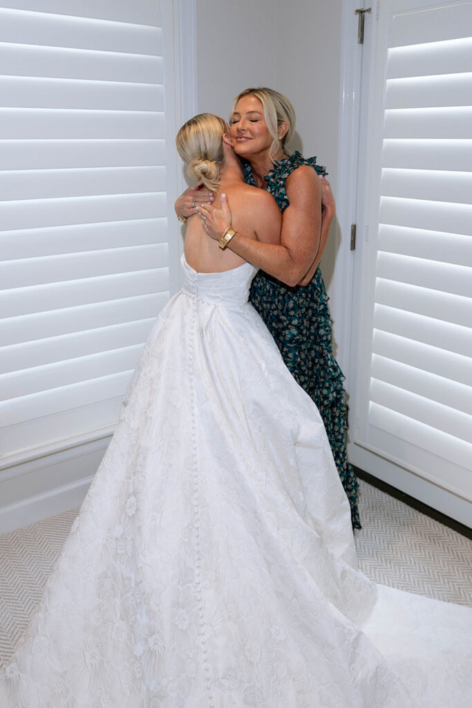 cute picture of the bride and her mom hugging