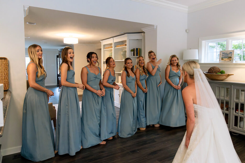 bridesmaids emotional seeing the bride in her wedding dress