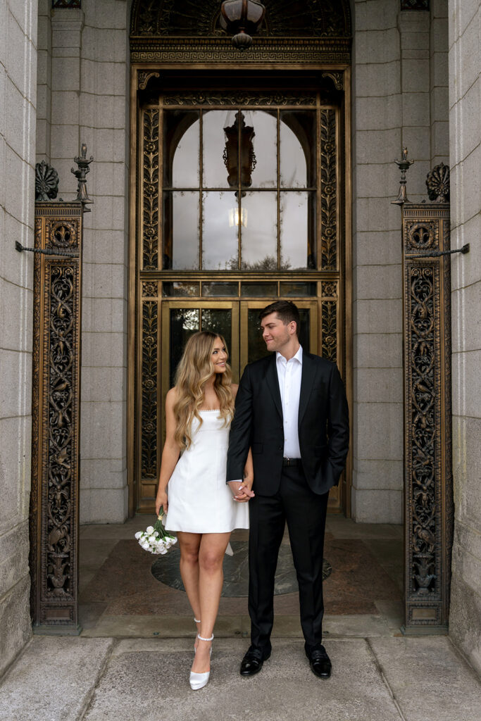 picture of the newly engaged couple smiling at each other