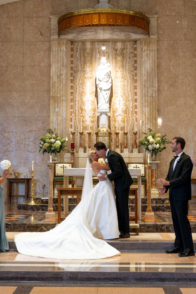bride and groom kissing after their ceremony
