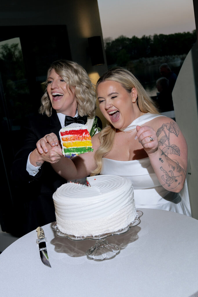 Happy couple trying their wedding cake
