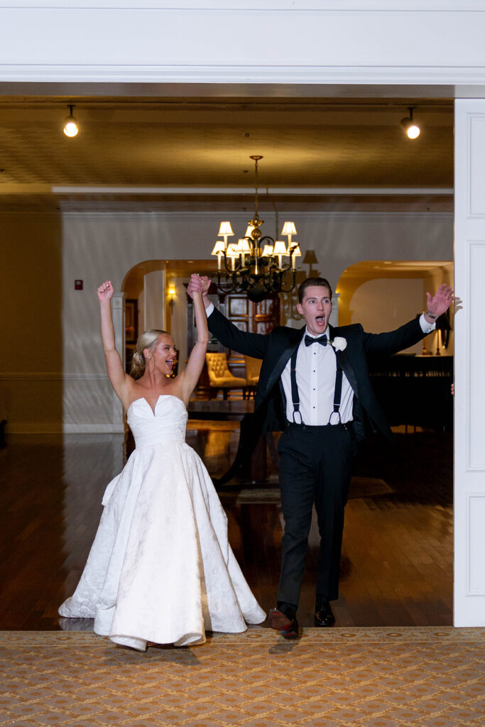 newlyweds entering their reception party