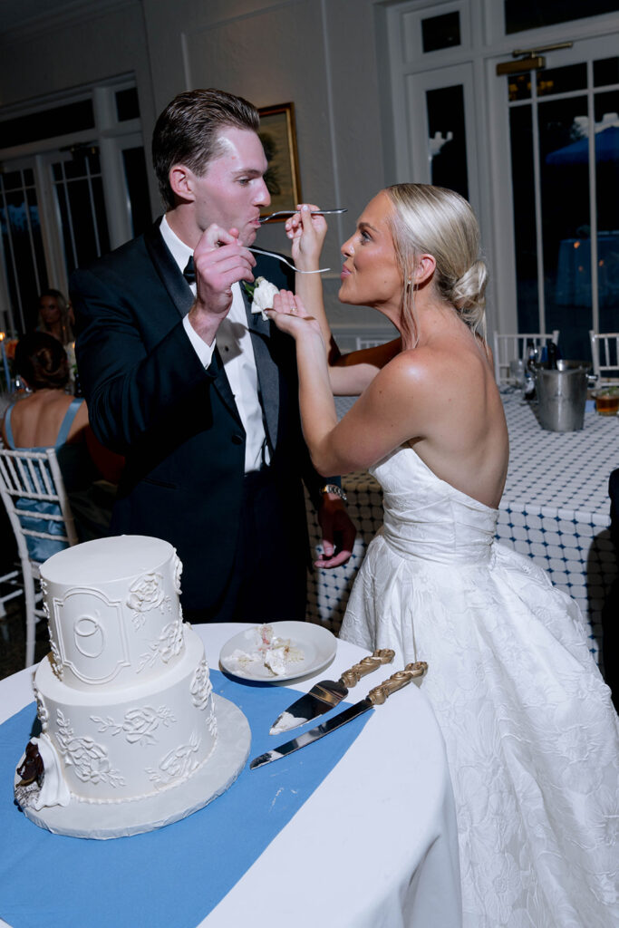newlyweds trying their wedding cake
