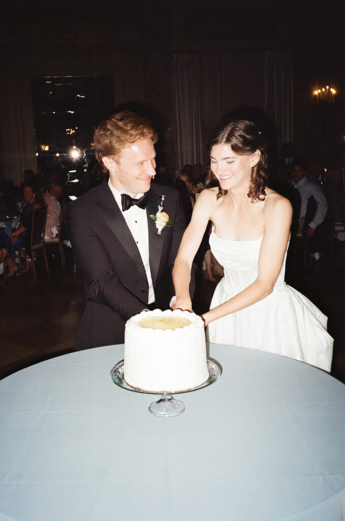 bride and groom cutting their wedding cake
