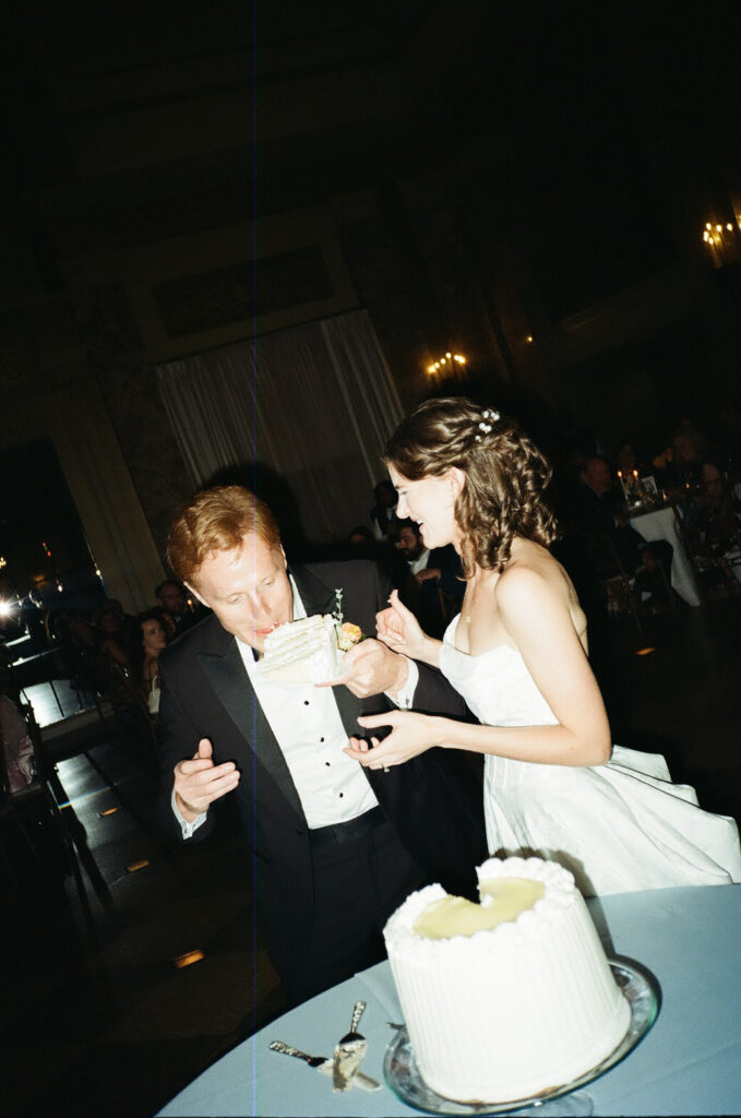 newlyweds trying their wedding cake