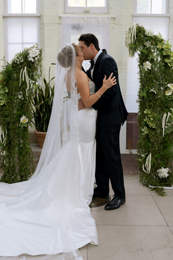 bride and groom kissing after their ceremony