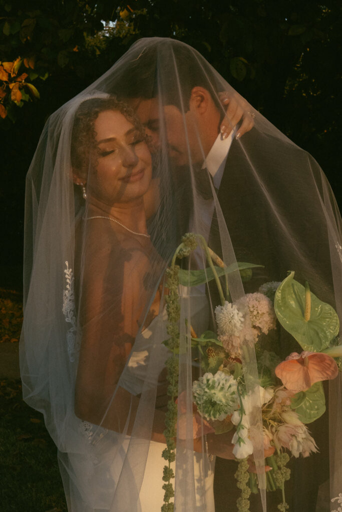 groom kissing the bride on the cheek
