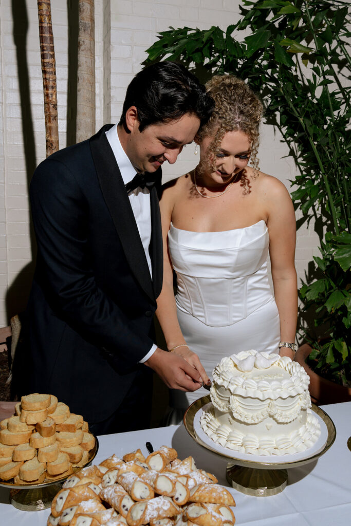 cute picture of the newlyweds cutting their wedding cake