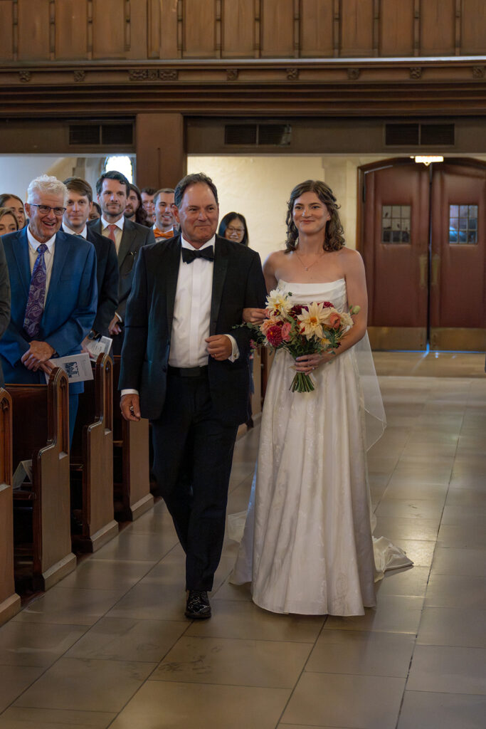 cute portrait of the bride walking down the aisle 