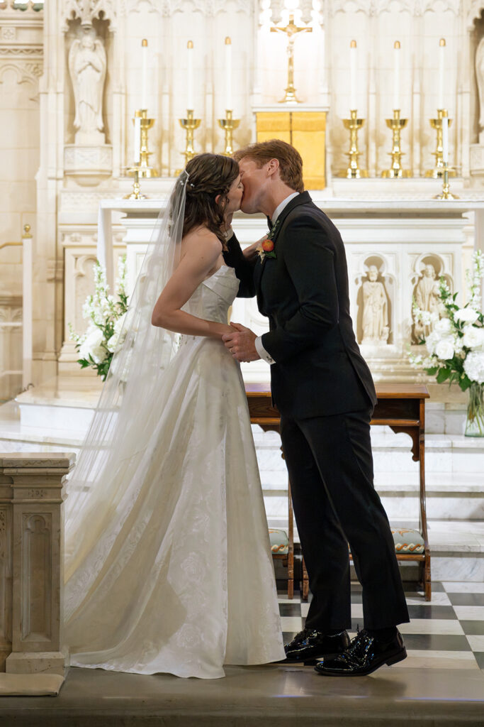 bride and groom kissing after their ceremony