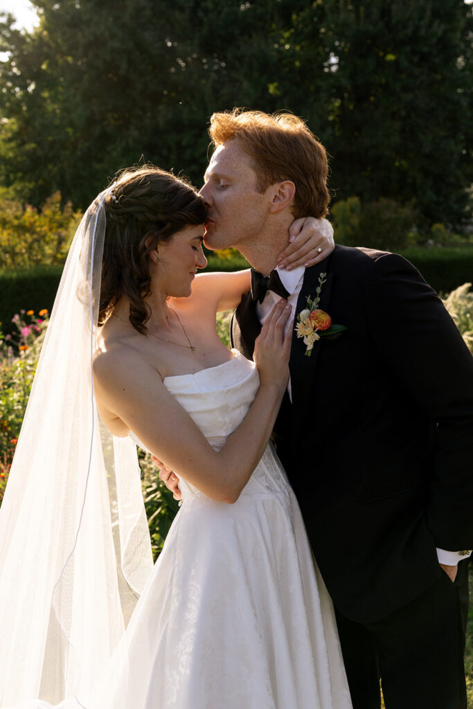 groom kissing the bride on the forehead