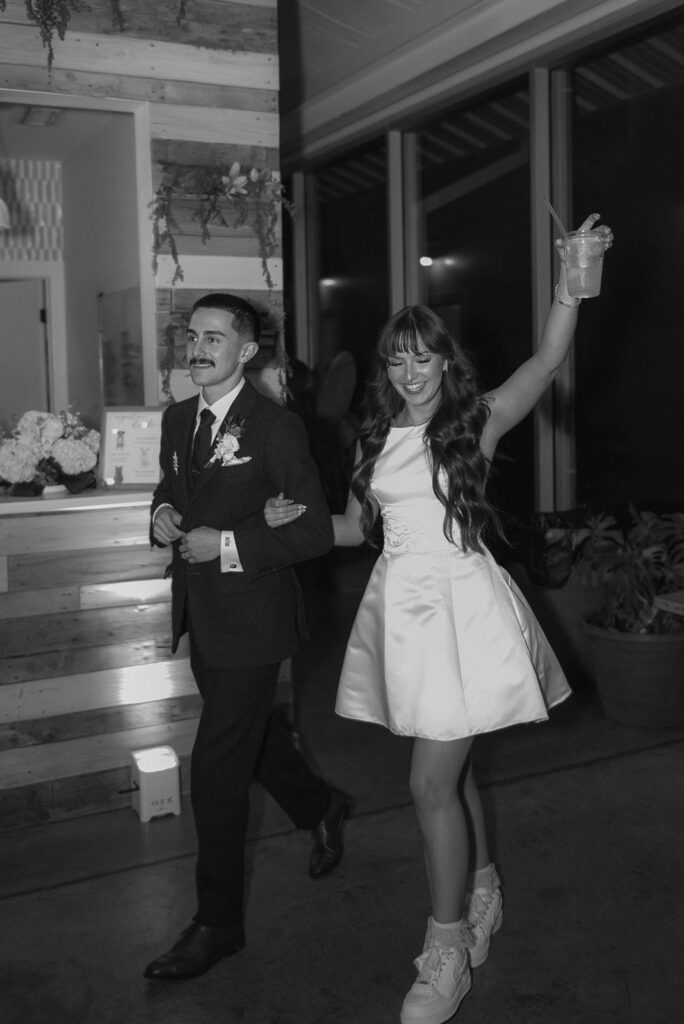 cute picture of the newlyweds arriving at their wedding reception