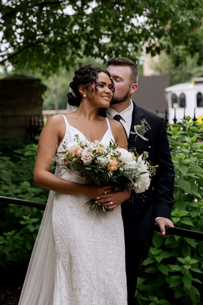 groom kissing the bride on the cheek
