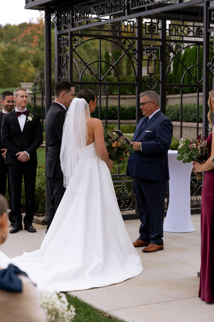 Bride and groom holding hands during their ceremony
