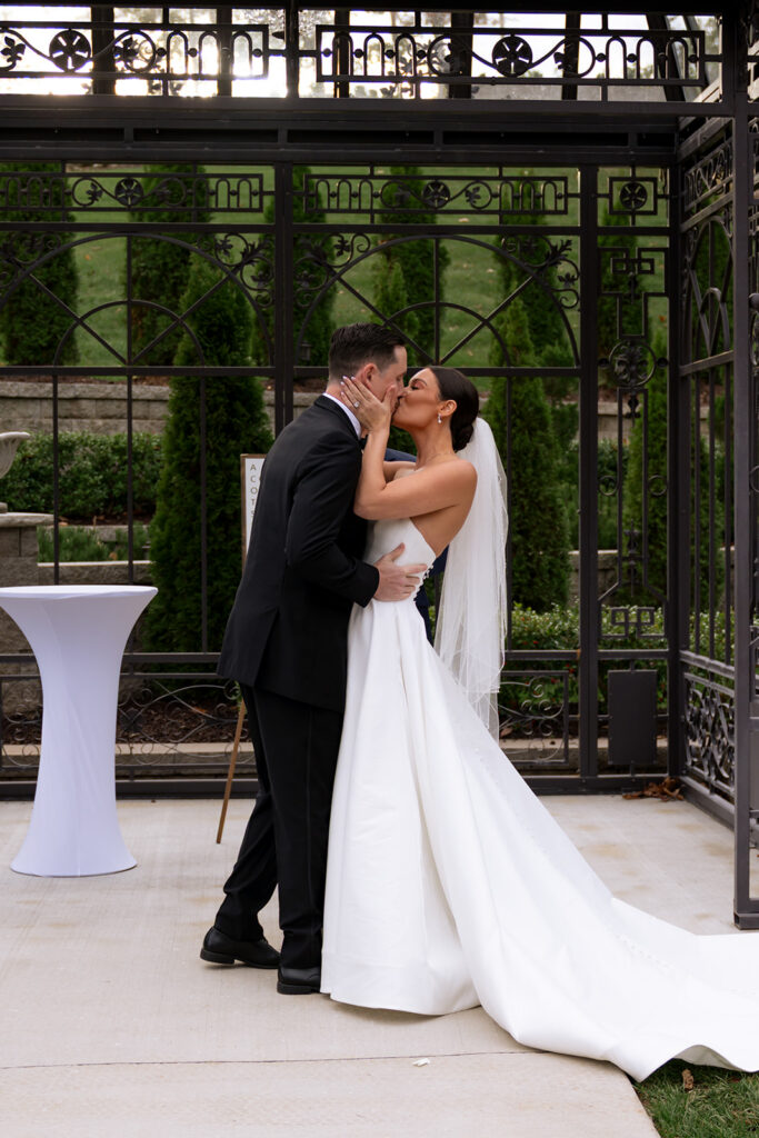 Bride and groom, kissing after their ceremony