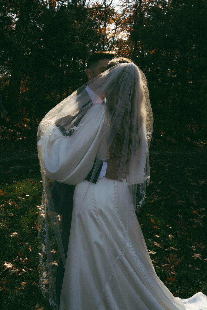 cute picture of the bride and groom kissing during their bridal portraits