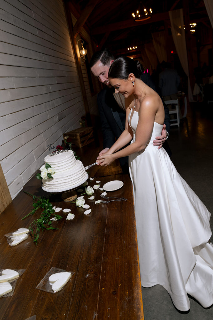 newly married couple cutting their wedding cake