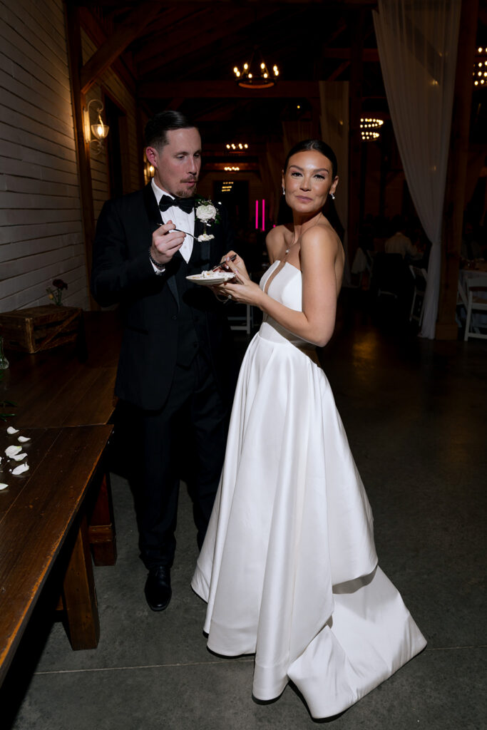 newly married couple trying their wedding cake