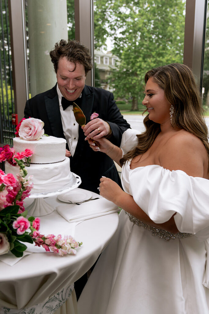 cute picture of the newlyweds cutting their wedding cake