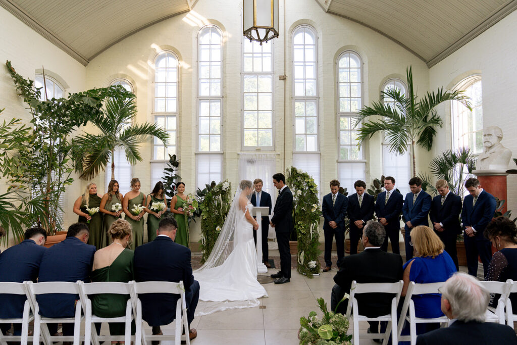 Bride and groom holding hands during their wedding ceremony