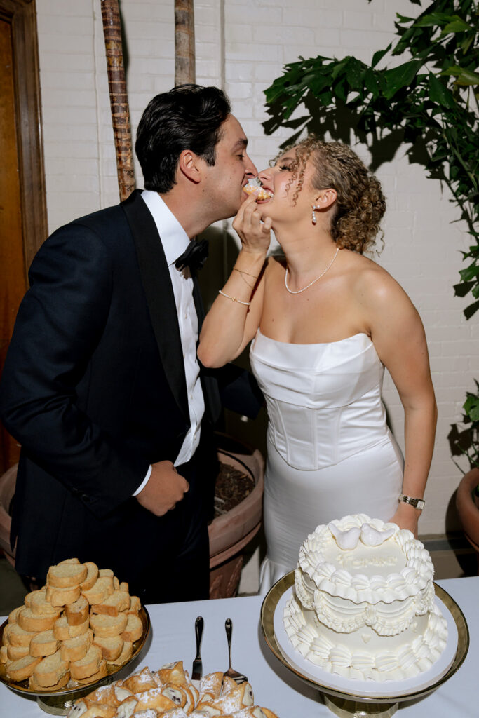 newlyweds cutting their wedding cake