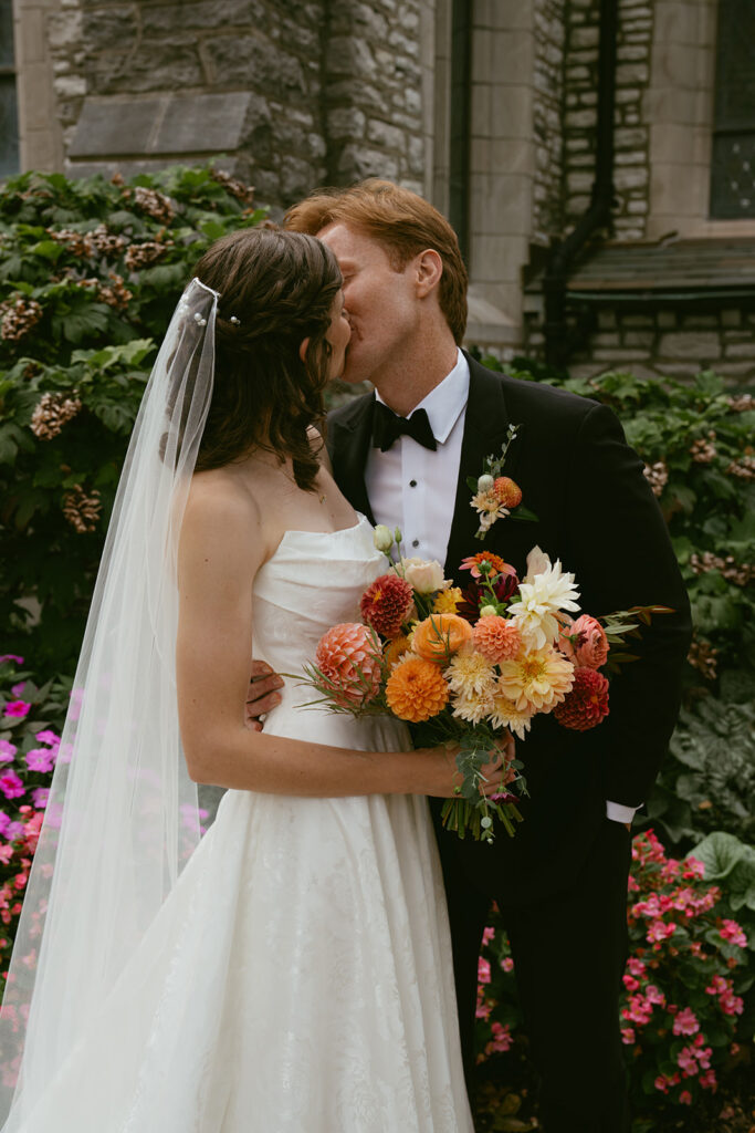 portrait of the bride and groom kissing