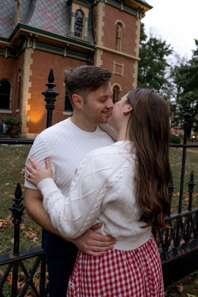 cute picture of the newly engaged couple kissing