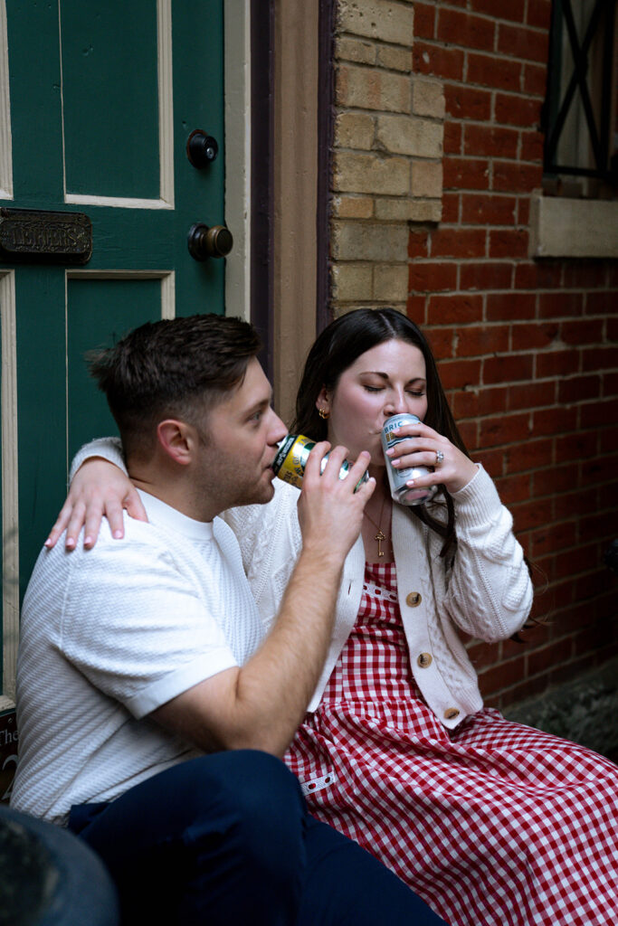 couple celebrating their engagement with drinks