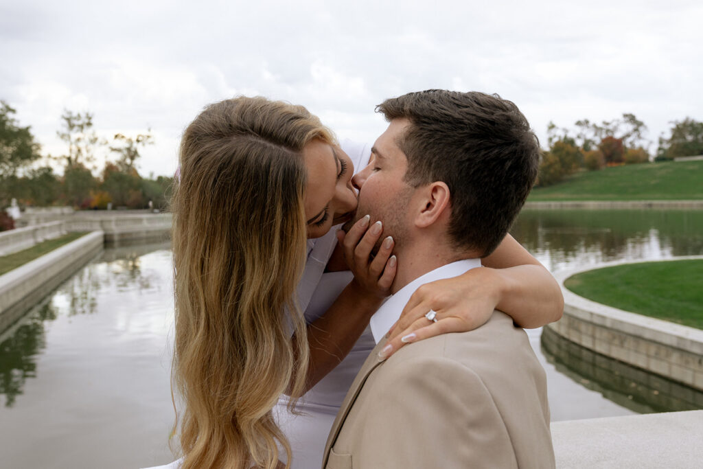 cute picture of the newly engaged couple kissing during their photoshoot