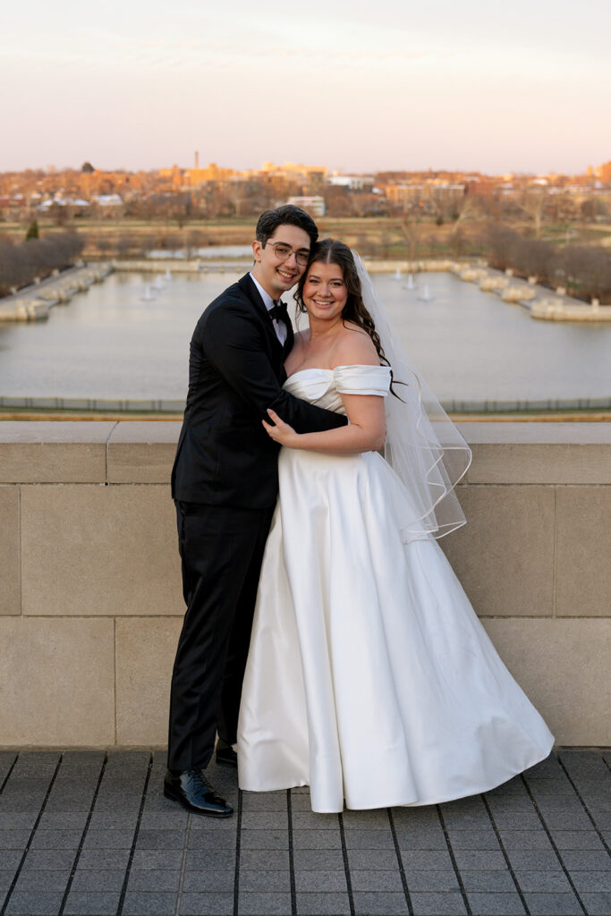 cute picture of the newlyweds smiling at the camera